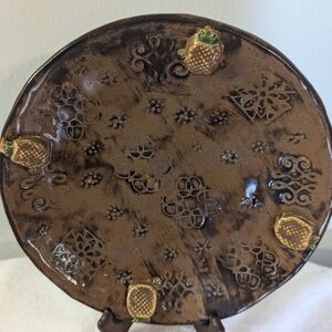 Decorative Handmade Pottery Plate with Pineapple Accents.